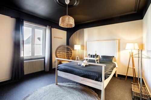 a bedroom with a bed and a window at Japan Universe Spa & Arcade in Mulhouse