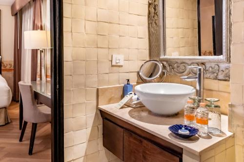 a bathroom with a sink and a mirror at Quinta Real Puebla in Puebla