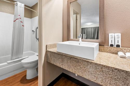 a bathroom with a sink and a toilet at Red Roof Inn Columbus West - Hilliard in New Rome