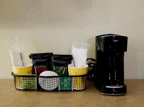 a coffee maker sitting on a counter next to a coffee pot at Red Roof Inn Columbus West - Hilliard in New Rome