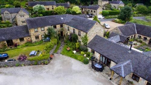 an aerial view of a large house with a driveway at #60 Remarkable 15thCentury Cottage with Lake Views - Near Lumsdale Waterfall - Sleeps 6 - Perfect for Contractors and Families - Free Parking in Hopton