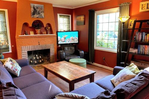 a living room with a couch and a table at North Portland 2BR Garden Home - Walk to shops, food and transit in Portland
