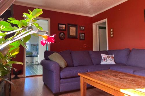 a living room with a purple couch and a table at North Portland 2BR Garden Home - Walk to shops, food and transit in Portland