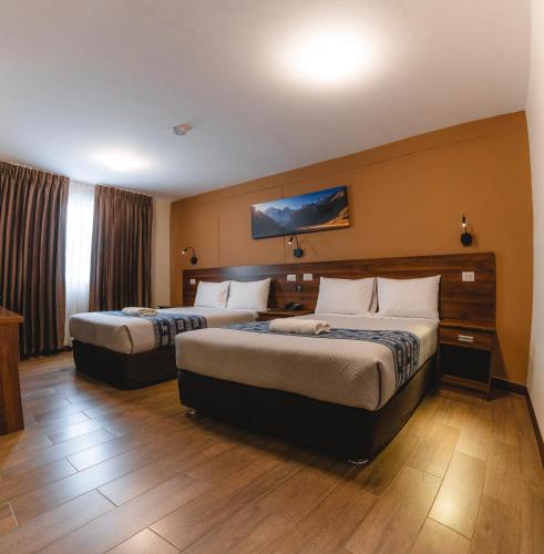 Postel nebo postele na pokoji v ubytování Cordillera Hotel
