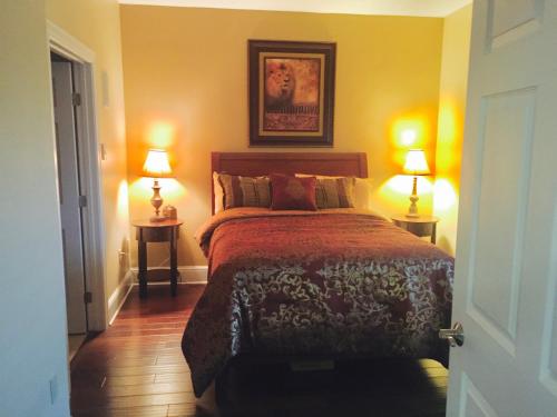 a bedroom with a bed and two lamps on two tables at Ocean Serenity in Pensacola