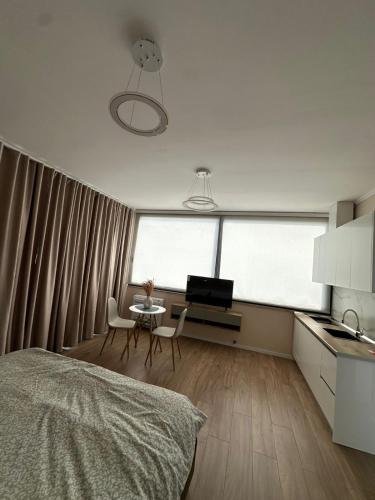 a bedroom with a bed and a table with chairs at Air B&B Hotel in Rrëshen