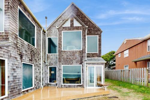 a brick house with glass doors andwindows at Beach Loop Condo #2 - South Unit in Bandon
