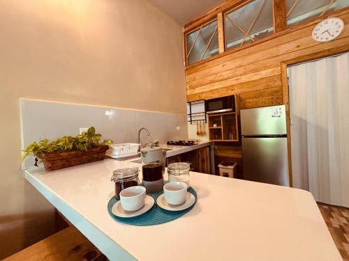 a kitchen with two cups and saucers on a counter at Villas MAMALU in Cocles