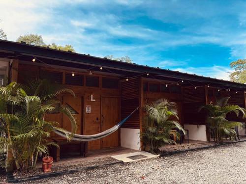 a house with a hammock in front of it at Villas MAMALU in Cocles