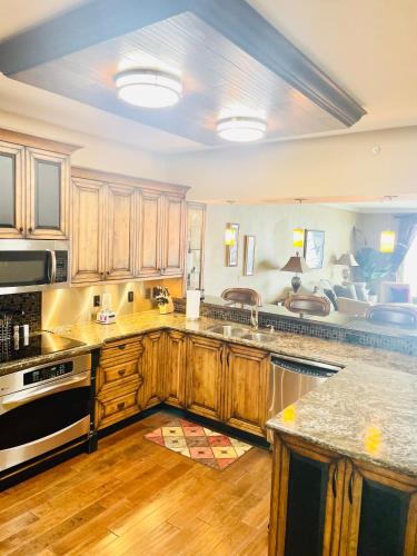 a kitchen with wooden cabinets and a counter top at Ocean Serenity in Pensacola
