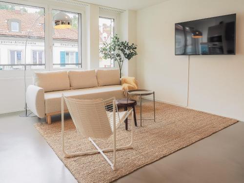 a living room with a couch and a table at Modernes Hostel, Privatzimmer in Shared Apartment- 6min zur Olma Messe in St. Gallen