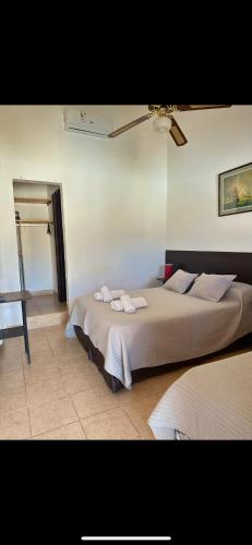 a bedroom with a bed with towels on it at Hosteria Torol Calta in Villa Cura Brochero