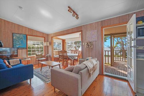 a living room with a couch and a table at Rowse House Hyams Beach in Hyams Beach