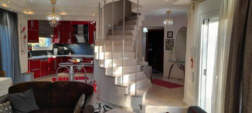 a kitchen with red cabinets and a staircase in a room at Indepented Residence Serres in Levkón