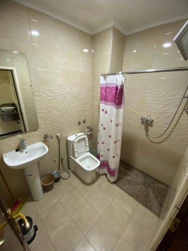 a bathroom with a toilet and a sink at Residence el michouar in Laayoune
