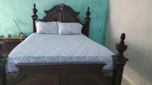 a bedroom with a bed with a wooden headboard at Bayview Luxury Retreat in Montego Bay