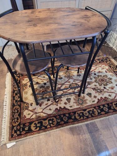 a wooden table and two chairs on a rug at Downtown Abbey @ DODD in Atlanta