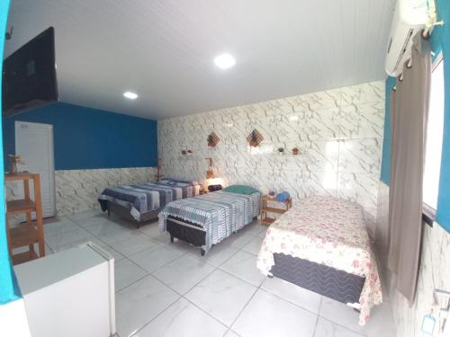 a bedroom with two beds in a room at Pousada Sítio Boas Novas in Caucaia