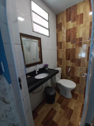 a bathroom with a sink and a toilet at Pousada Sítio Boas Novas in Caucaia