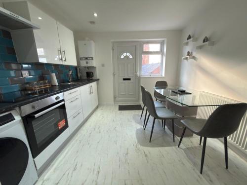 a kitchen with a table and chairs and a dining room at Axion property in Swindon