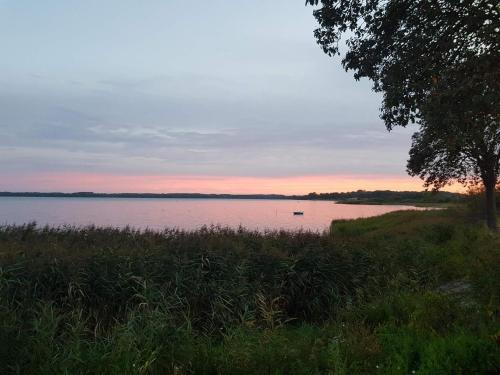 a view of a lake with a boat in the water at Seaside Escape in Praesto - By Traum Ferienwohnungen in Mosebølle