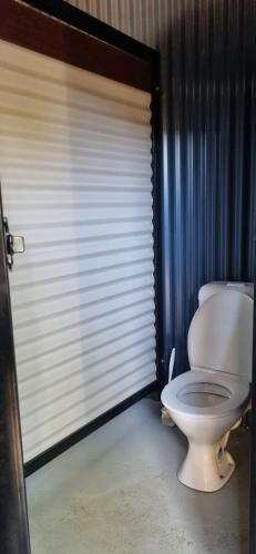 a bathroom with a white toilet in a room at One Life Live It Farm stay in Dareton