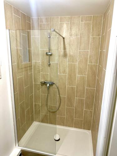 a shower with a glass door in a bathroom at réf rog Chambre Privée dans une villa partagée in Magny-le-Hongre