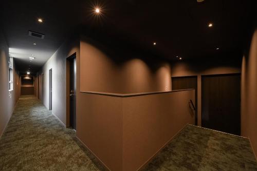 a hallway with a large wall in a room at Hotel Yatsu in Komatsu