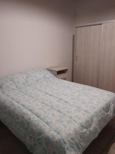 a bedroom with a bed and a wooden cabinet at Sol de Abril in Russell