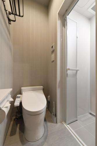 a bathroom with a toilet and a shower at Hotel Yatsu in Komatsu