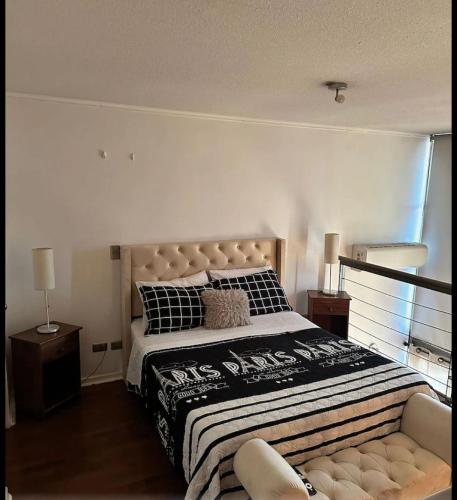 a bedroom with a large bed and a couch at Loft Rousse Travel in Santiago