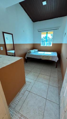 Ένα ή περισσότερα κρεβάτια σε δωμάτιο στο Chalés Residência Tatiane