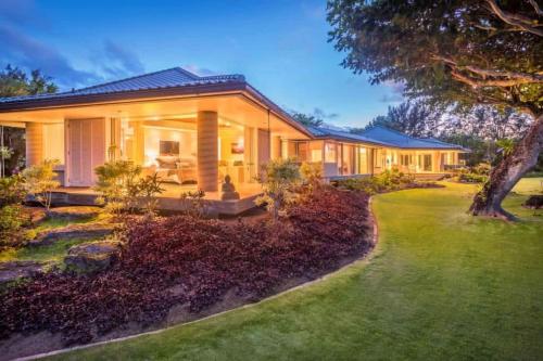 a large house with a garden in front of it at Utopia Beach Front Estate in Kalihiwai