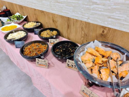 a table with many different types of food on it at APA Hotel Sagamihara Hashimoto Eki Higashi in Sagamihara