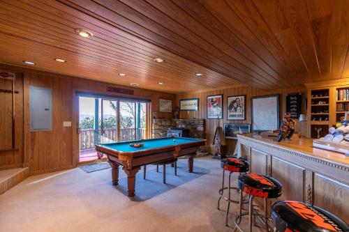 a billiard room with a pool table and a bar at On Any Sunday in Blowing Rock