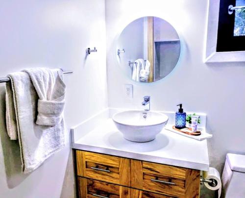 a bathroom with a sink and a mirror at Curacion Beach Resort in Brick Bay