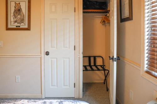 a white door in a room with a chair at Yellowstone Gateway Inn in Gardiner
