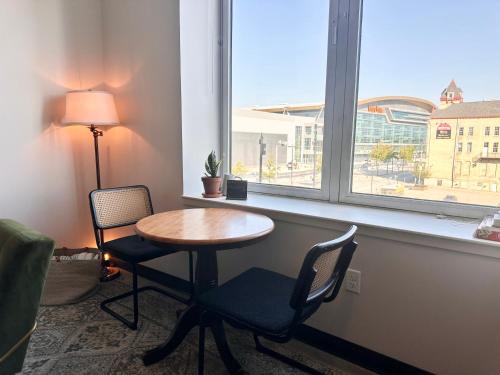 a room with a table and two chairs and a window at Deer District Studio Apt - One Block from Fiserv and Baird in Milwaukee