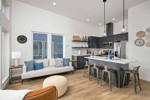 a kitchen and living room with a couch and a table at Ebb920 Modern Loft, Heart of Taft District in Lincoln City