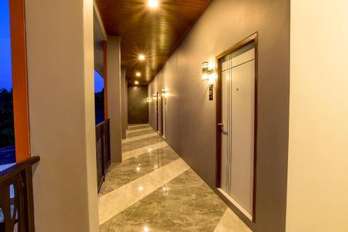 a hallway of a house with a walkway at The Breezy Hotel in Muaklek