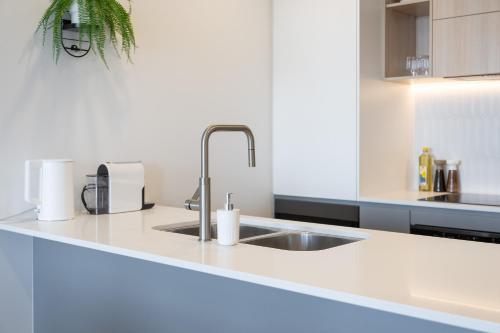 a kitchen with a sink and a counter top at Stylish Woden 2BR, Near Hospital, CIT, Westfield in Phillip