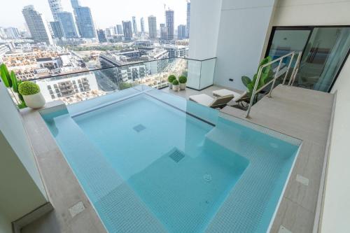 a large swimming pool on top of a building at Free housekeeping visits during your stay - StayShort - Luxury 2BR with Private Pool & Skyline Terrace JVC in Dubai