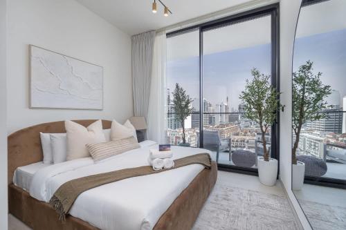 a bedroom with a large bed and a large window at Free housekeeping visits during your stay - StayShort - Luxury 2BR with Private Pool & Skyline Terrace JVC in Dubai