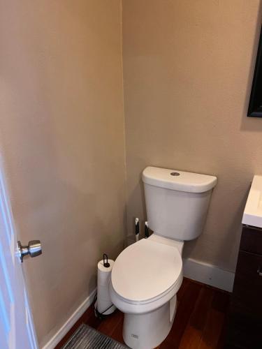 a bathroom with a white toilet and a sink at Amazing Wood streets studio in Riverside