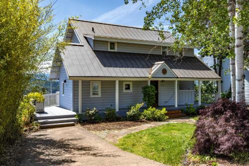 a white house with a metal roof at Grandview Get-A-Way home in White Salmon