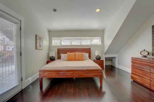 a bedroom with a bed with orange pillows on it at Surfs Up Spacious Hood River Home - 30 Day Minimum Stay home in Hood River
