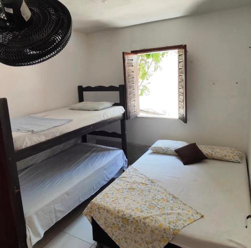 Ένα ή περισσότερα κρεβάτια σε δωμάτιο στο Chalés Residência Tatiane