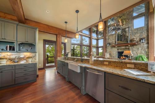 a large kitchen with wooden floors and a large island at Overlook at Wilderness Trail in Newland