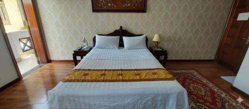 a bedroom with a large bed with two night stands at Melody Riverside Homestay in Thôn Trường Giang