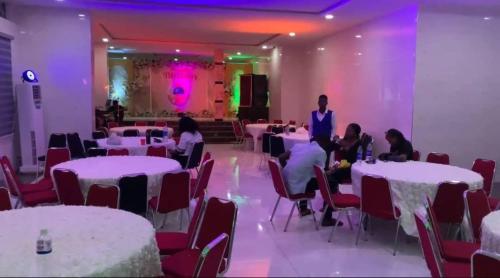 a group of people sitting at tables in a room at Gold Rhino Hotel and Suites Ltd in Enugu